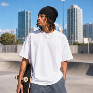 Man with locs wearing the black skull cap at a skatepark