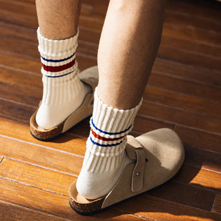 Cream crew socks with blue and red stripes, seen from behind