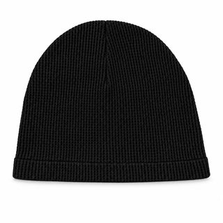 Black waffle knit skull cap on a white background
